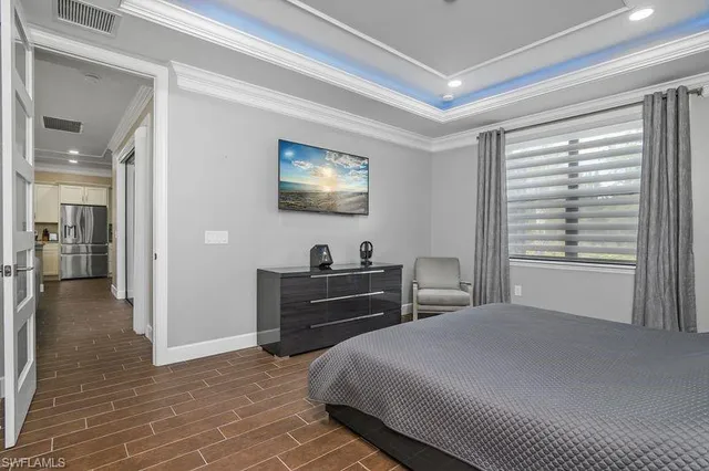 a bedroom with a bed and a flat screen tv