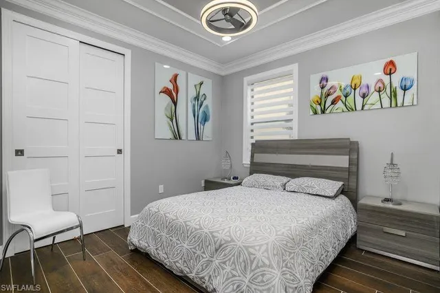 a bedroom with a bed and painting on the wall
