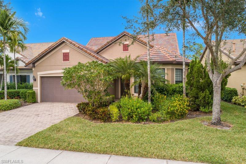 16309 Winfield Lane Naples, FL 34110 - Photo 2 of 36 a view of a white house next to a yard with potted plants