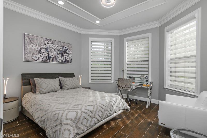 16309 Winfield Lane Naples, FL 34110 - Photo 21 of 36 a bedroom with a bed and wooden floor