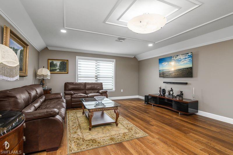 16309 Winfield Lane Naples, FL 34110 - Photo 23 of 36 a living room with furniture and a flat screen tv