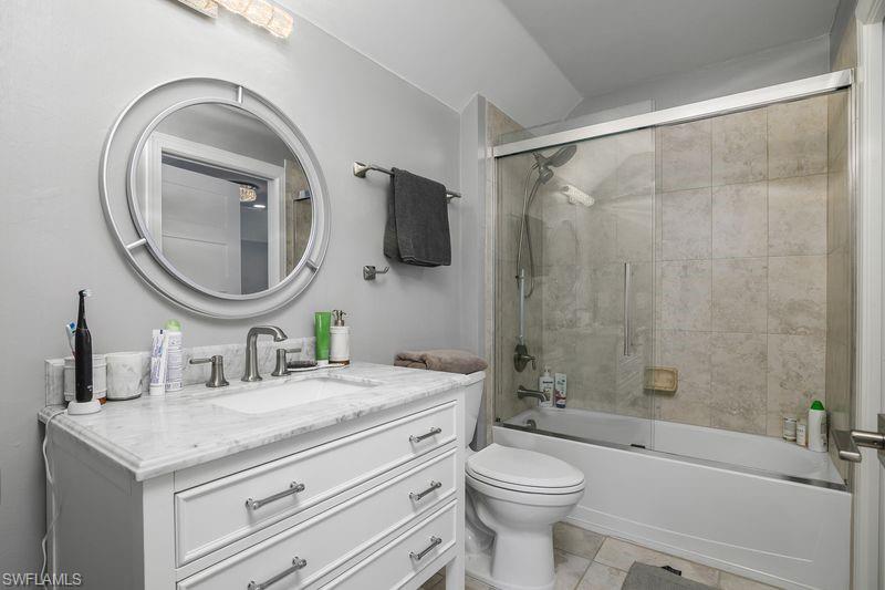 16309 Winfield Lane Naples, FL 34110 - Photo 26 of 36 a bathroom with a granite countertop sink a toilet and a mirror