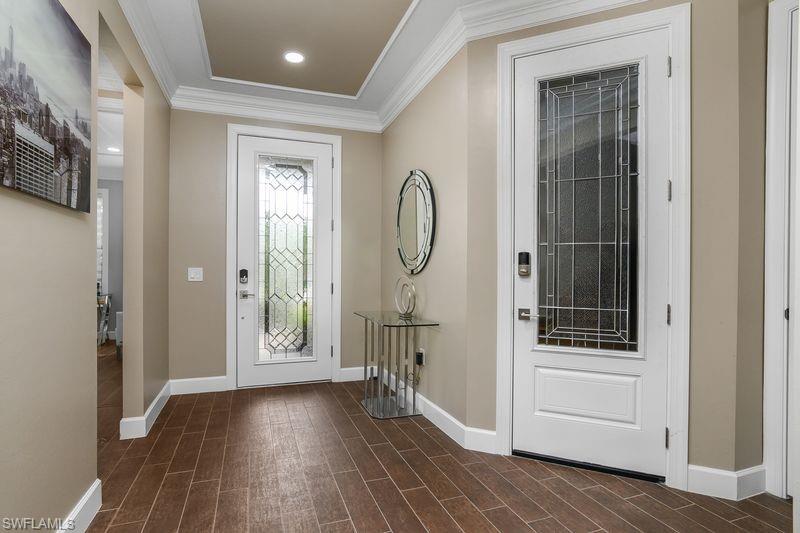 16309 Winfield Lane Naples, FL 34110 - Photo 4 of 36 a view of a hallway with wooden floor and entryway