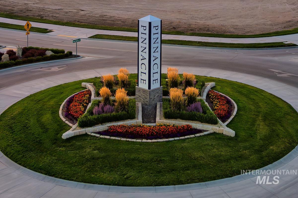 1735 East Acme Street Meridian, ID 83642 - Photo 2 of 8 Roundabout featuring a central monument, stone-edged planter beds, and varied landscaping