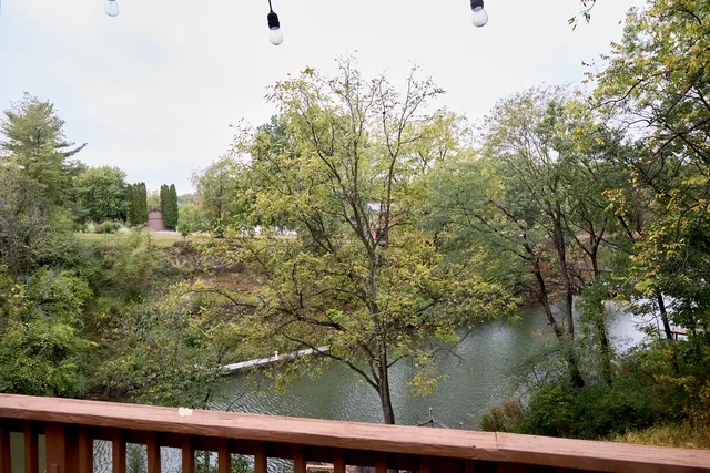 a kitchen with stainless steel appliances granite countertop a sink refrigerator and cabinets