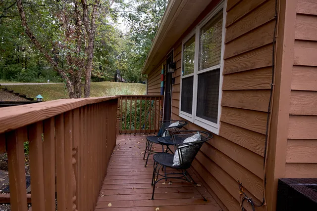 a living room with wooden floor and a flat screen tv