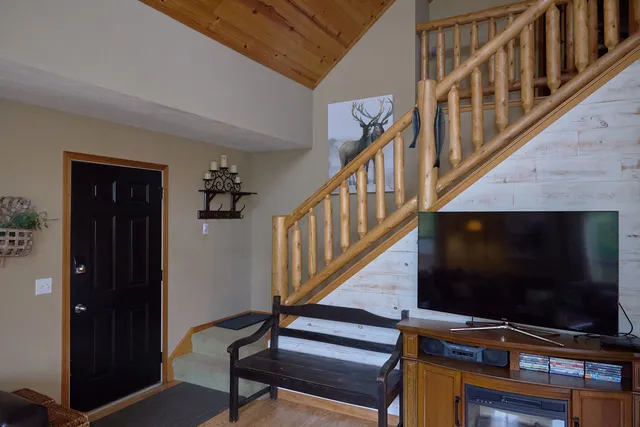 a bedroom with a bed and a chandelier