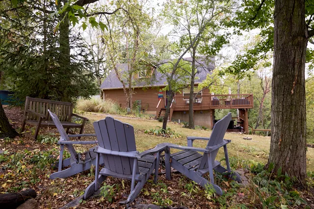 a view of a balcony with chairs and wooden floor
