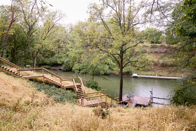 a view of a balcony with wooden floor and fence