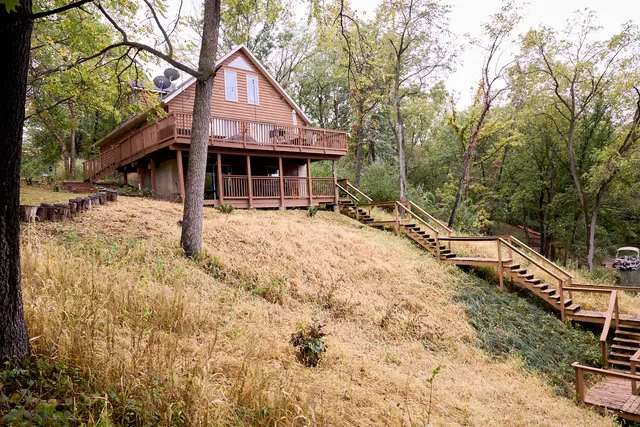 a balcony with wooden floor and outdoor seating