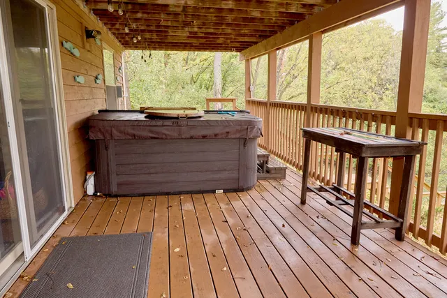 a view of a balcony with chairs and wooden floor