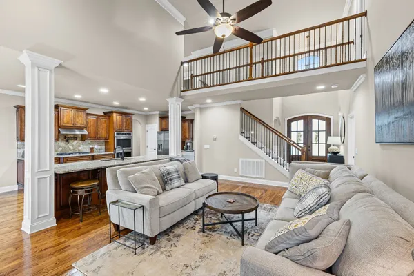 a living room with furniture ceiling fan and a rug