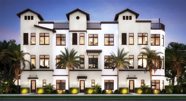 a front view of multiple houses with yard