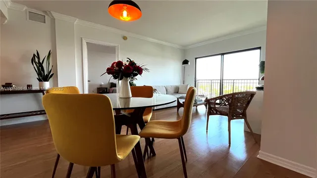 a dining room with furniture and window