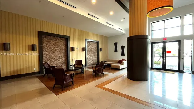 a living room with furniture large window and flat screen tv