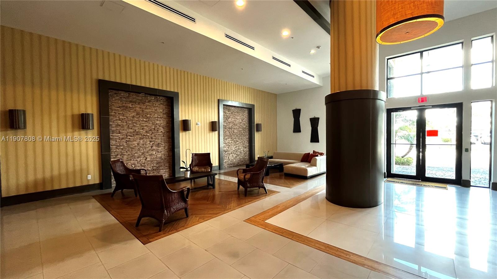 4242 Northwest 2nd Street, Unit 703 Miami, FL 33126 - Photo 24 of 25 a living room with furniture large window and flat screen tv