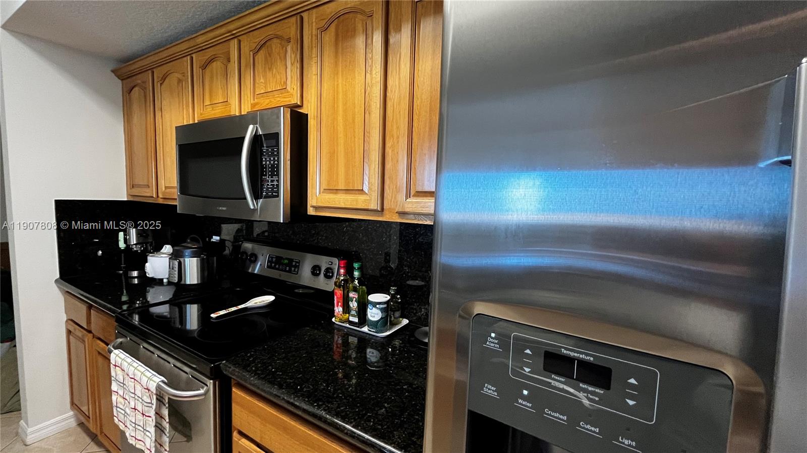 4242 Northwest 2nd Street, Unit 703 Miami, FL 33126 - Photo 6 of 25 a kitchen with a sink and cabinets