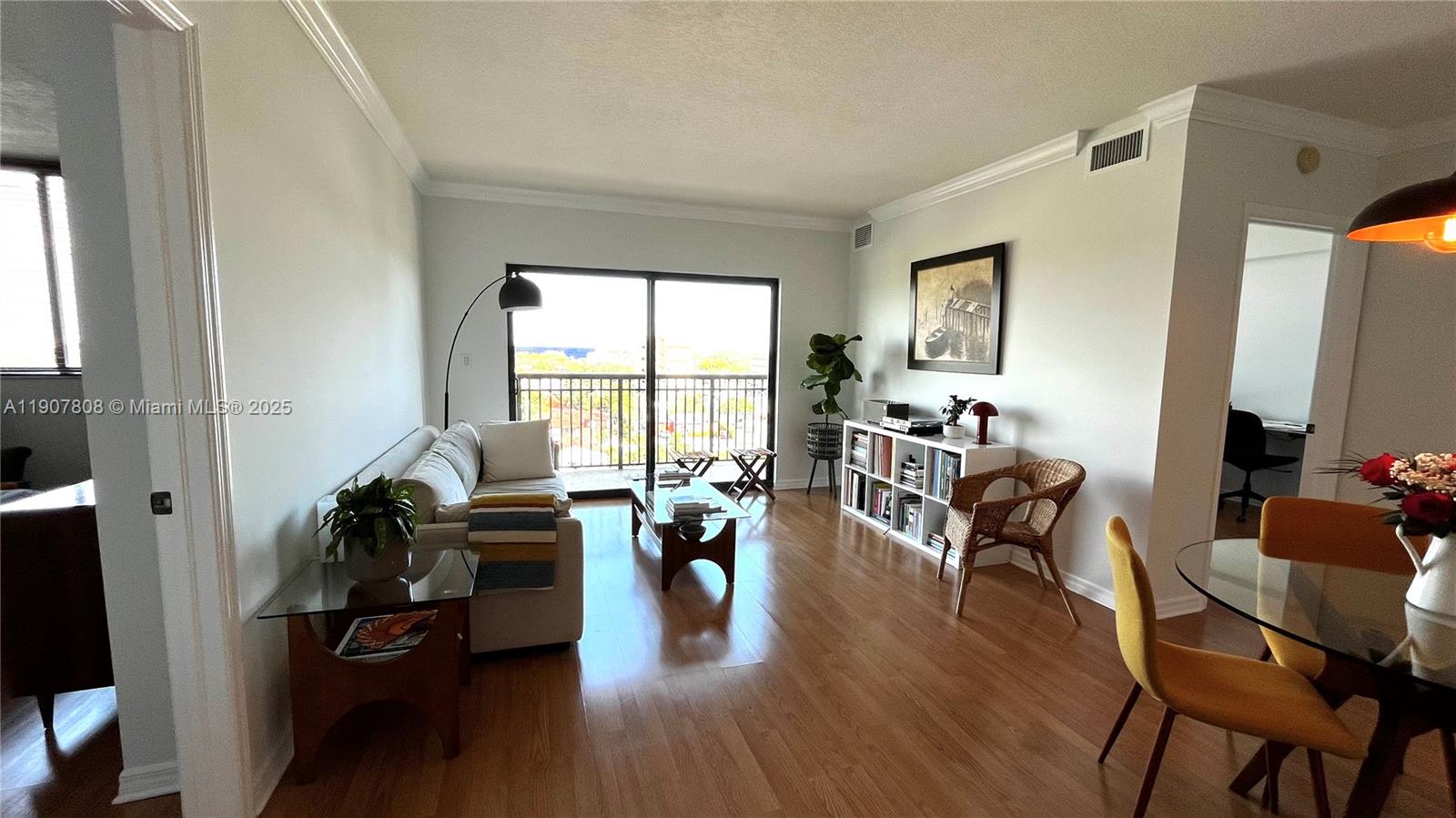 4242 Northwest 2nd Street, Unit 703 Miami, FL 33126 - Photo 7 of 25 a living room with furniture floor to ceiling window and wooden floor