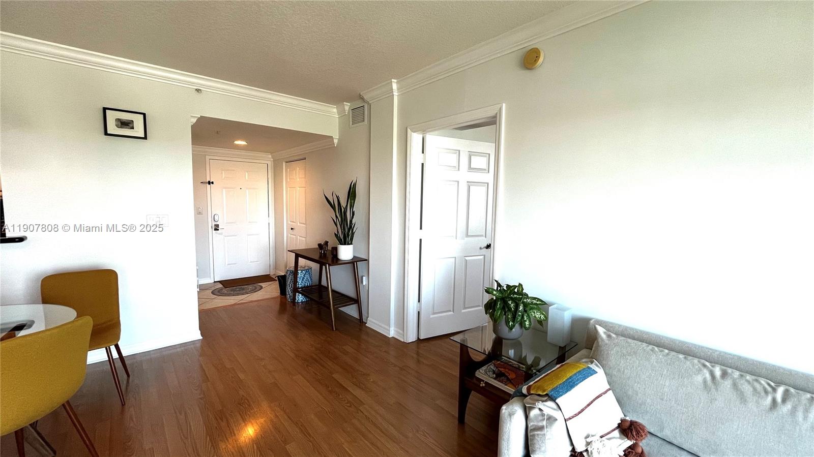 4242 Northwest 2nd Street, Unit 703 Miami, FL 33126 - Photo 8 of 25 a living room with furniture and a table