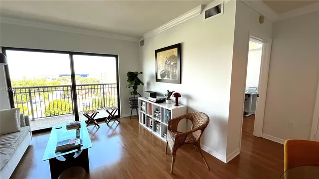 a living room with furniture and floor to ceiling windows