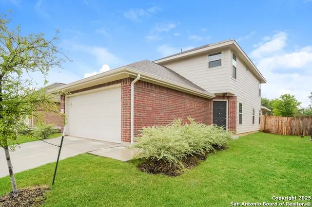a front view of house with a garden