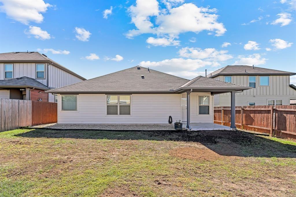 235 Limerick Road Buda, TX 78610 - Photo 11 of 11 Back of property featuring a patio area, a fenced backyard, and a shingled roof