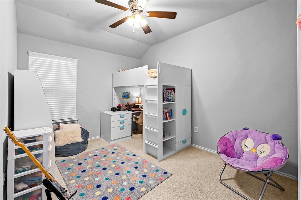 235 Limerick Road Buda, TX 78610 - Photo 3 of 11 Bedroom featuring vaulted ceiling, light carpet, and a ceiling fan