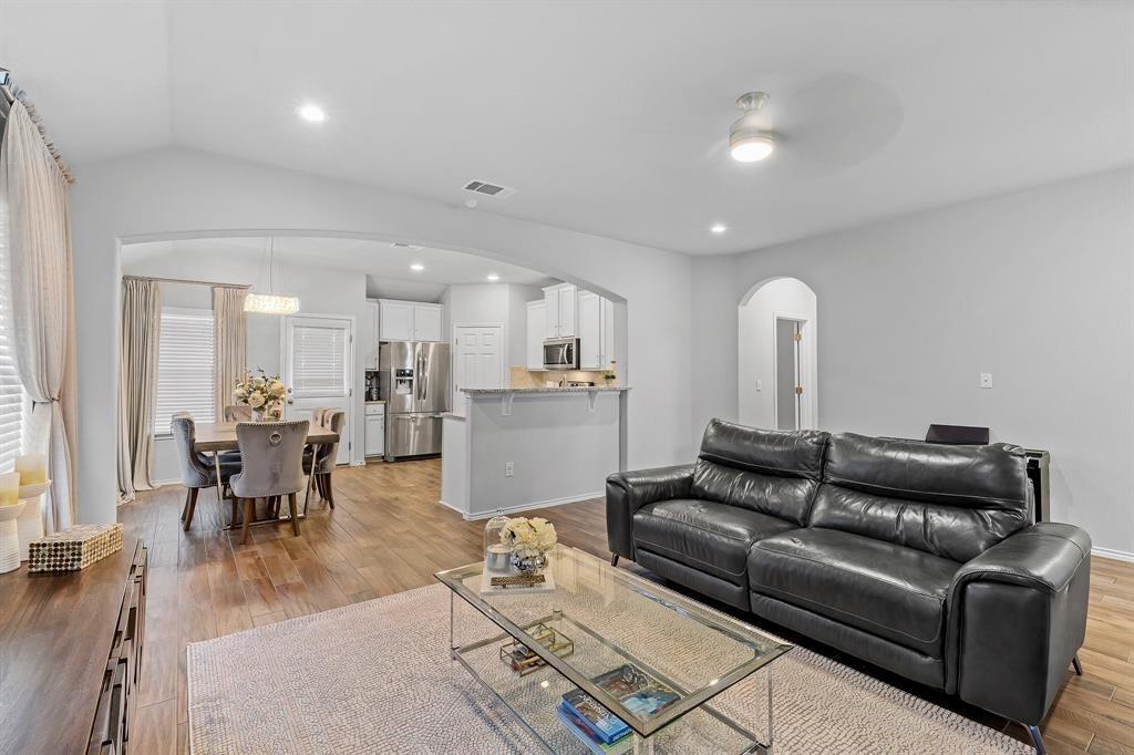 235 Limerick Road Buda, TX 78610 - Photo 4 of 11 Living area with arched walkways, light wood finished floors, recessed lighting, and a ceiling fan
