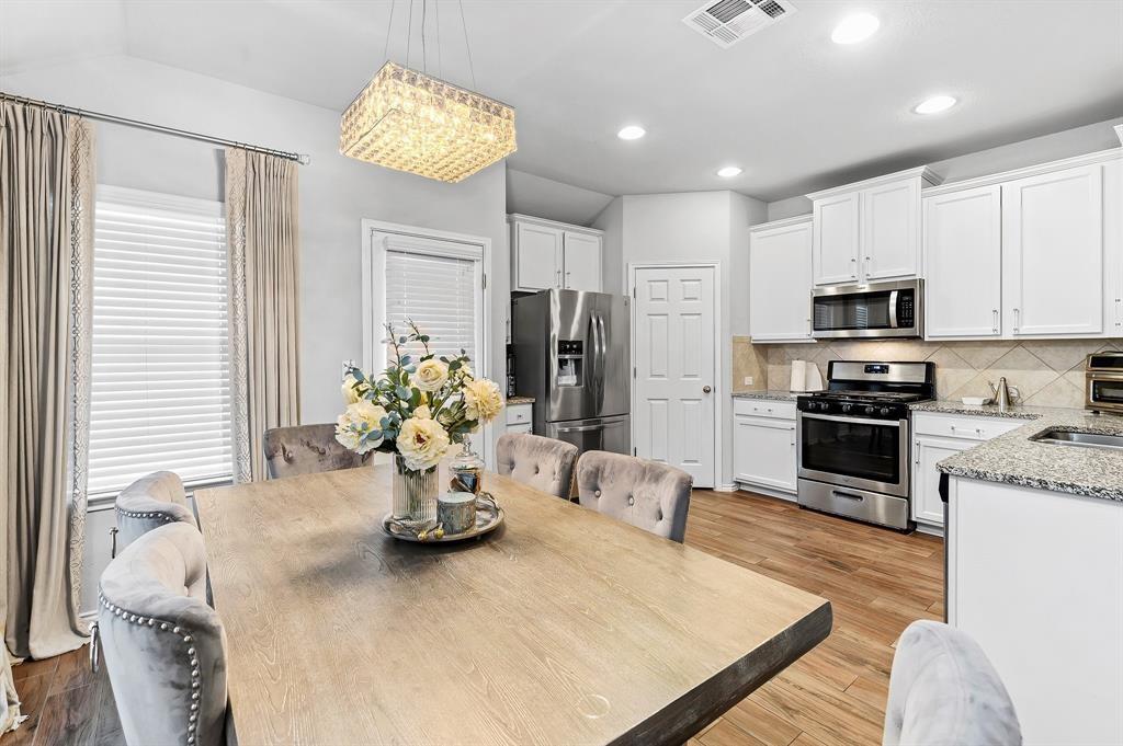 235 Limerick Road Buda, TX 78610 - Photo 6 of 11 Dining room featuring light wood-type flooring and a chandelier