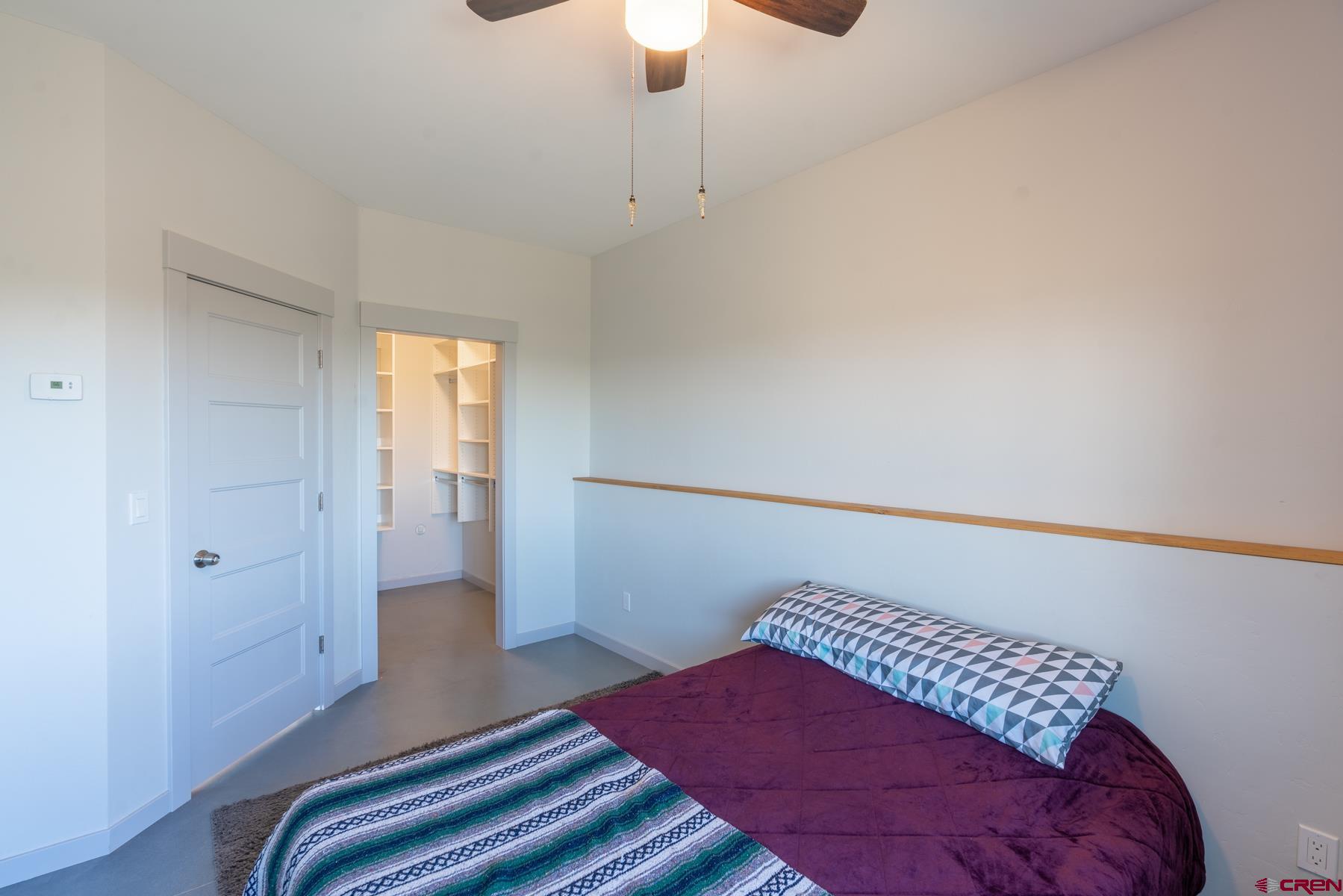 68 Cody Road Durango, CO 81303 - Photo 24 of 35 a bedroom with a bed and a chandelier