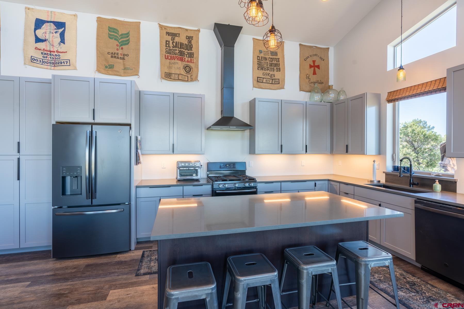 68 Cody Road Durango, CO 81303 - Photo 9 of 35 a kitchen with granite countertop a refrigerator and wooden cabinets