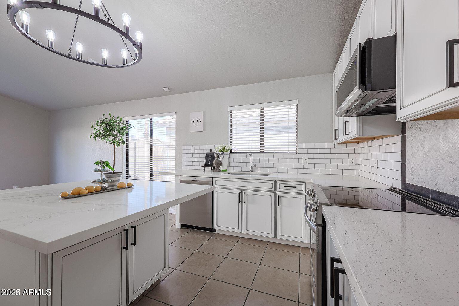 2134 East Robin Lane Phoenix, AZ 85024 - Photo 12 of 24 a kitchen with a sink and cabinets