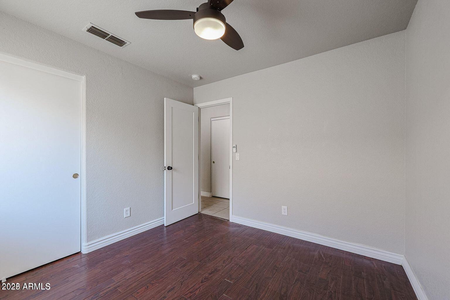 2134 East Robin Lane Phoenix, AZ 85024 - Photo 15 of 24 wooden floor in an empty room