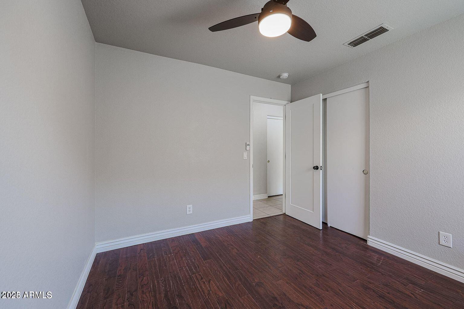 2134 East Robin Lane Phoenix, AZ 85024 - Photo 17 of 24 a view of an empty room with wooden floor