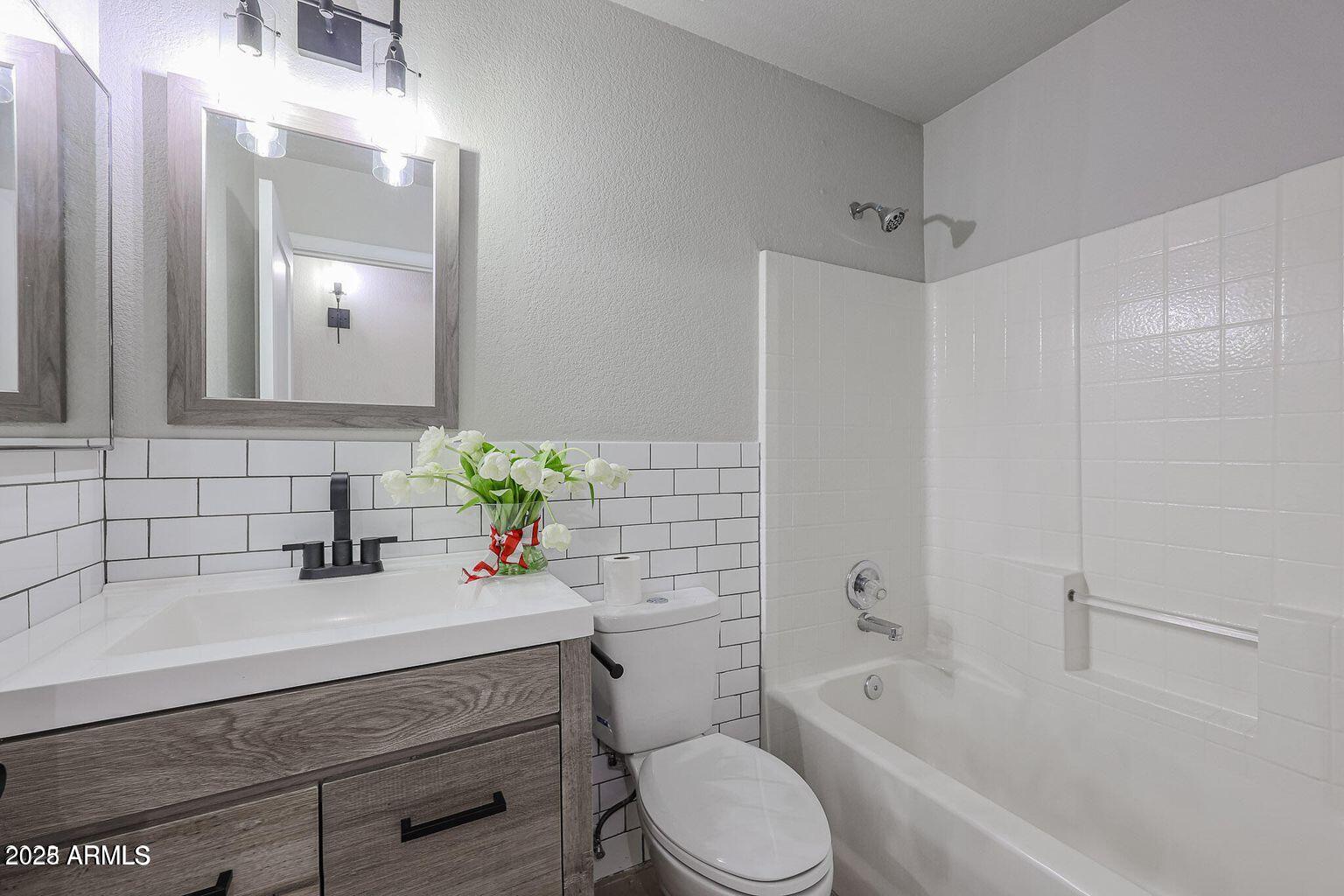 2134 East Robin Lane Phoenix, AZ 85024 - Photo 18 of 24 a bathroom with a sink a toilet and shower