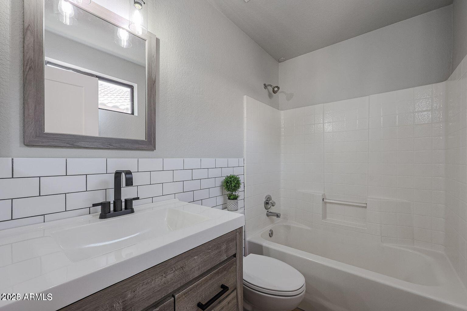 2134 East Robin Lane Phoenix, AZ 85024 - Photo 21 of 24 a bathroom with a sink a toilet and shower