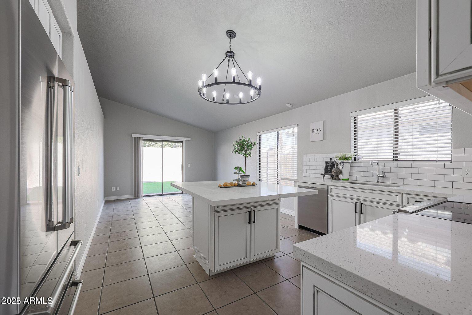 2134 East Robin Lane Phoenix, AZ 85024 - Photo 6 of 24 a kitchen with stainless steel appliances a stove a sink and a refrigerator