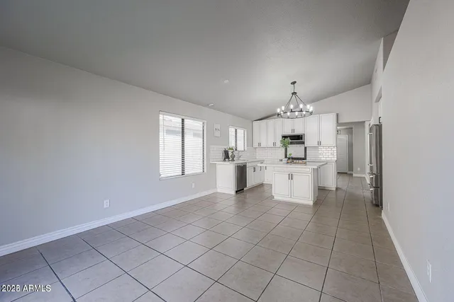 a large white kitchen with cabinets and a stainless steel appliances
