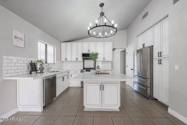 a kitchen with cabinets and stainless steel appliances
