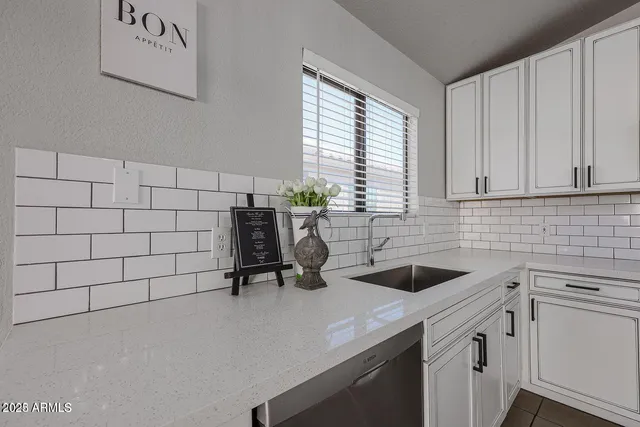 a view of a kitchen with a sink and cabinets