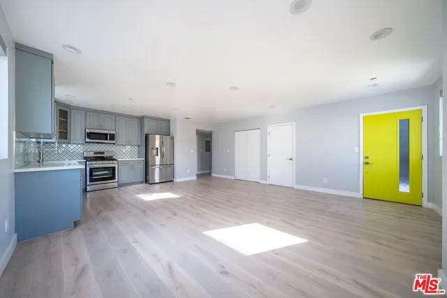 a view of a kitchen with a sink and a stove top oven