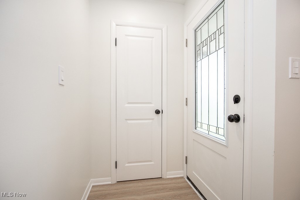 22210 Emery Road Cleveland, OH 44128 - Photo 2 of 32 Doorway with baseboards and light lvt flooring