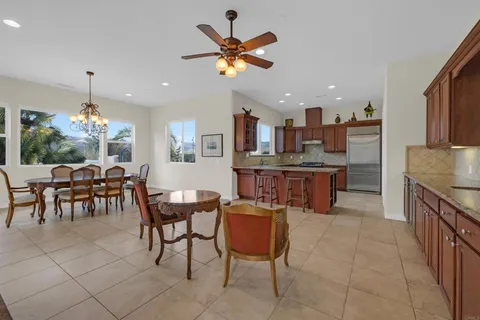 a dining room with furniture a chandelier and a rug
