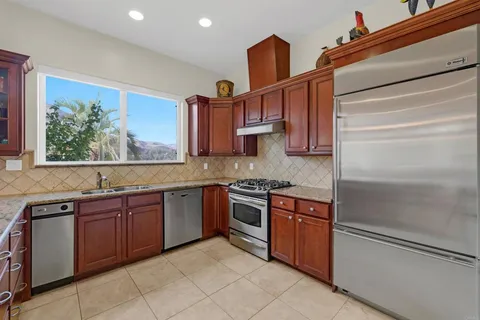 a bathroom with a granite countertop double vanity sink mirror and shower