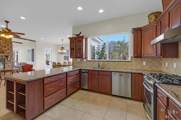 a bathroom with a granite countertop sink a mirror and a shower