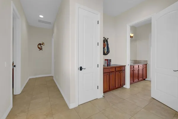 a en suite bathroom with a double vanity sink and a mirror