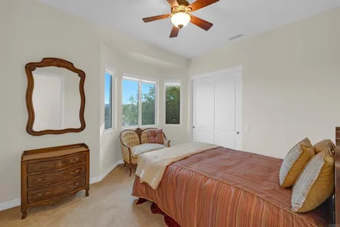 a bedroom with a bed and a large mirror