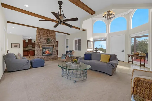 a living room with furniture and a chandelier