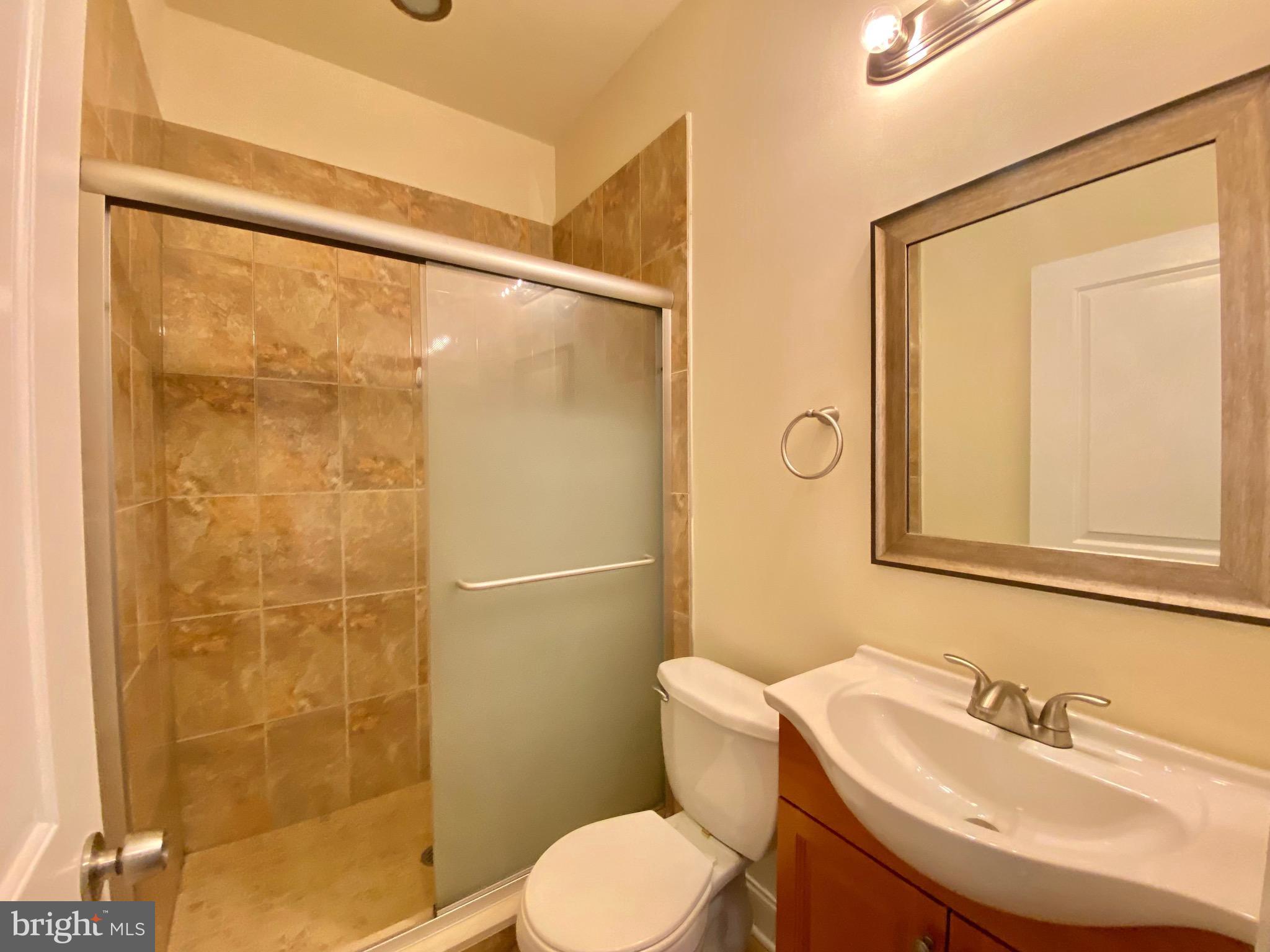 1419 North 17th Street, Unit C Philadelphia, PA 19121 - Photo 12 of 21 a bathroom with a sink mirror toilet and shower