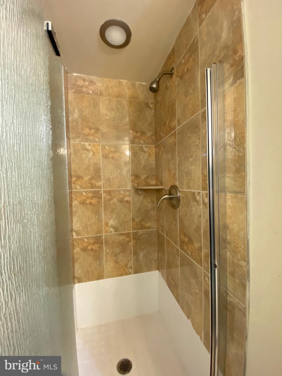 1419 North 17th Street, Unit C Philadelphia, PA 19121 - Photo 18 of 21 a bathroom with a shower and a bath tub